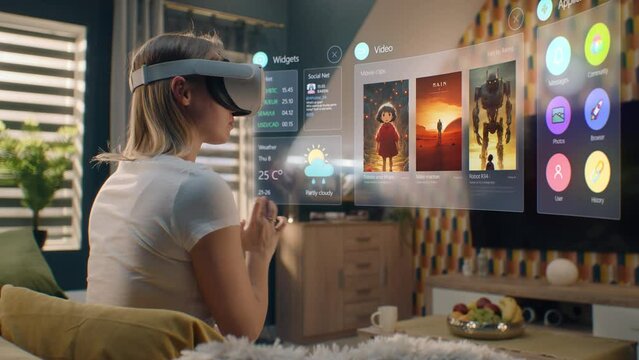Woman in augmented reality headset chooses movie or TV show to watch at home. 3D graphics shows interface of streaming service app and widgets in user menu. VFX animation. Entertainment and lifestyle.