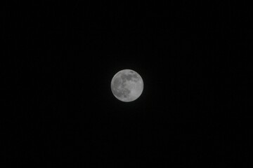 Bright full moon illuminates a clear night sky