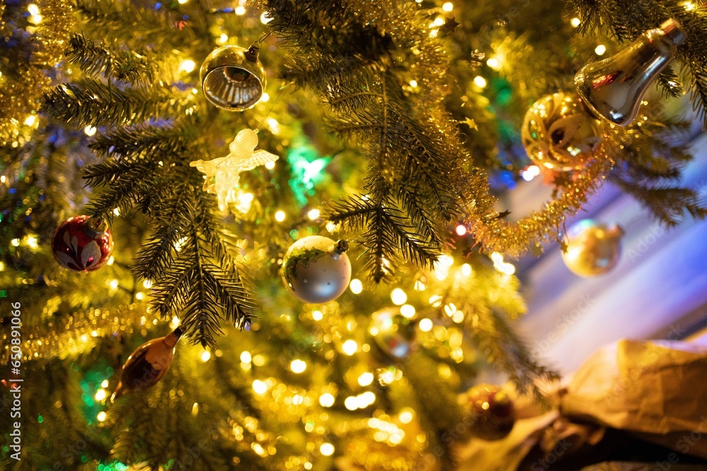 Poster festive christmas tree illuminated by bright lights, adorned with an array of colorful ornaments