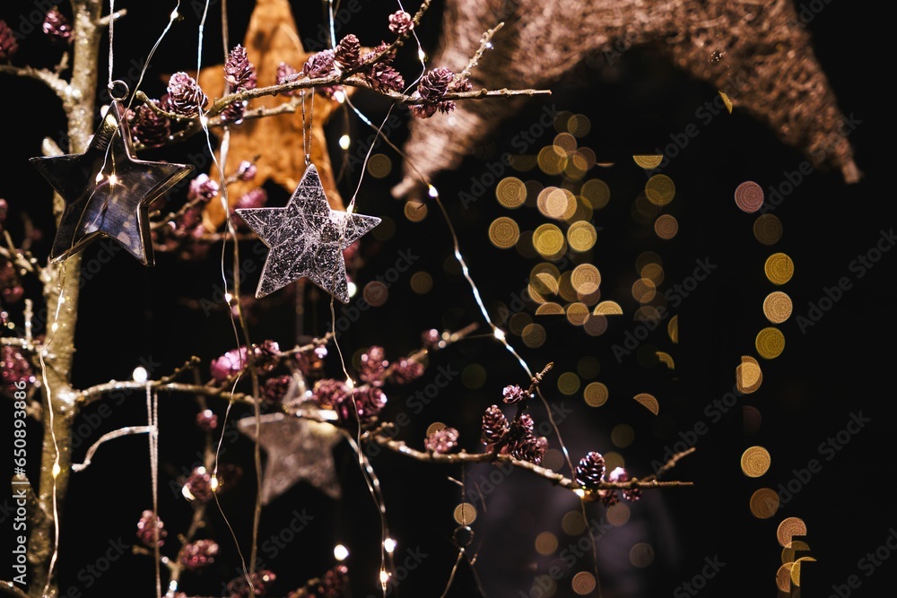 Poster festive scene featuring a tree adorned with colorful decorations illuminated by a soft light