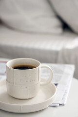 Saucer with cup of coffee on table, closeup