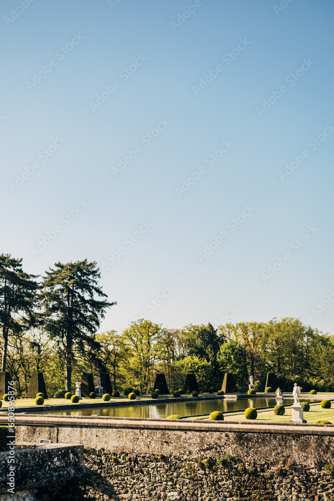 Canvas Prints vertical shot of the garden of the chateau de breteuil in choisel, france in blue sky background