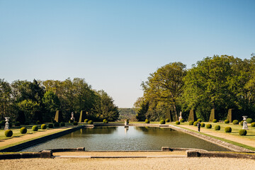 Scenic view of the garden of the Chateau de Breteuil in Choisel, France in blue sky background