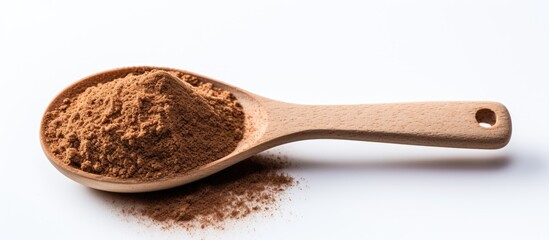 Isolated wooden spoon with coffee powder on white background