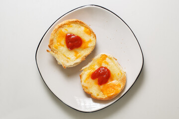 Delicious toasted cheese sandwich buns topped with pizza sauce