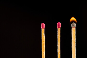 Matchsticks burned in the dark background.
