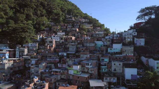 Aerial puling back to reveal colourful hillside favela houses in Rio de Janeiro, Brazil