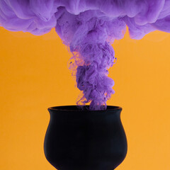 witch’s black pot steaming purple poison smoke for haloween