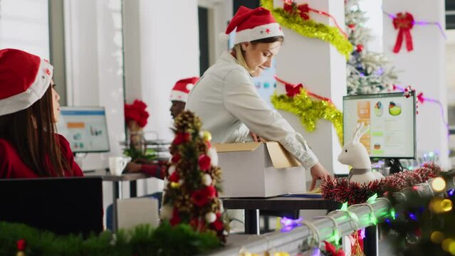 Pissed employee packs desk belongings and steals Christmas office ornaments on last day at work to feel better. Vengeful woman getting fired from job during layoffs, delighted about retribution
