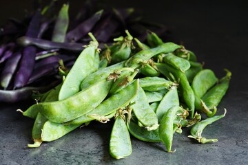 Fresh and healthy vegetables: Raw green sugar peas and purple beans   - 650909051