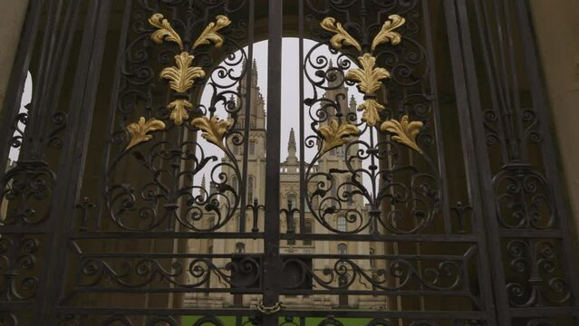 Panning view beautiful exterior gates ornamental decorations. Closed Oxford university behind gate bars. Architecture british schools education in UK concept