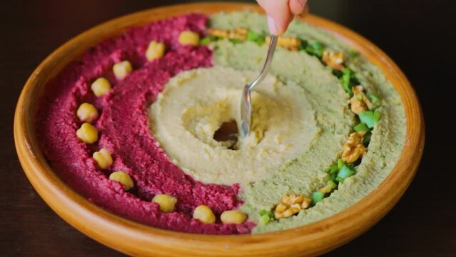 Cook the bacon and put it on top of the hummus. Preparing delicious traditional Middle Eastern cuisine appetizer Hummus.