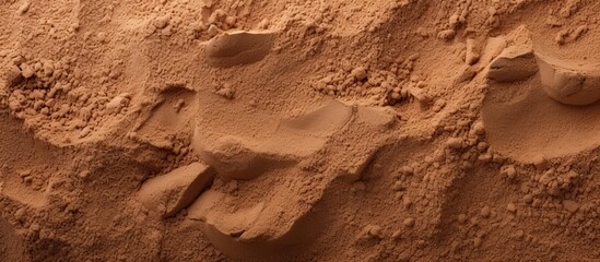 Fototapeta premium Top view of natural sandy beach background with brown dry sand texture