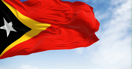 National flag of East Timor waving in the wind on a clear da