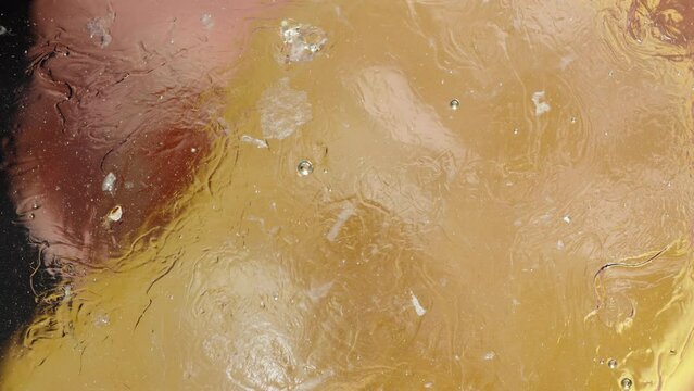 The concept of dissolving fat using lemon juice. Lemon juice dissolves sweet honey. Macro view.