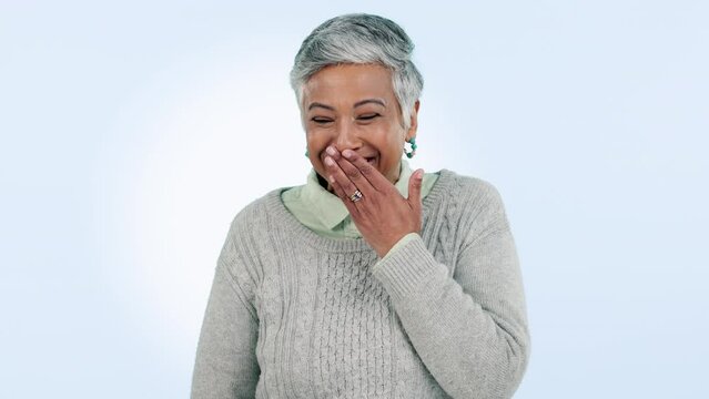 Happy, woman and funny gossip with hand on face and control laughing with secret, confidential or crazy news in studio. Mature, lady and surprise announcement, news or hide smile on mouth for joke