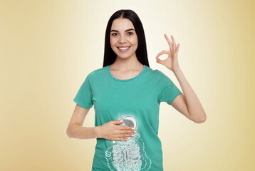 Happy woman with healthy digestive system on light yellow background. Illustration of gastrointestinal tract - obrazy, fototapety, plakaty
