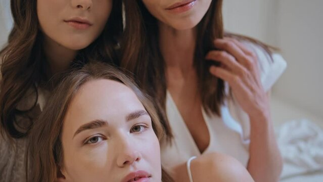 Closeup beautiful girl posing with attractive sisters. Charming family portrait.