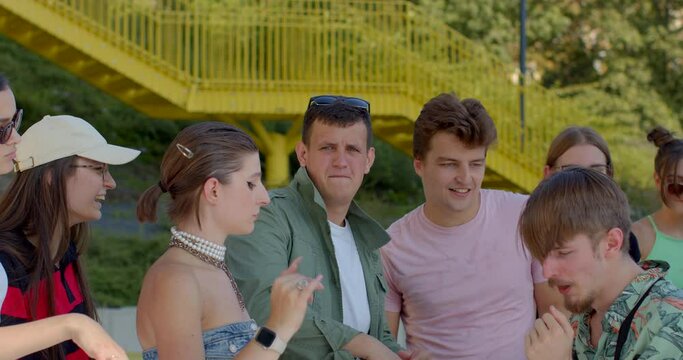 Young males support during communal activity. Dancers come together in group or crew to practice or perform. Collaborative routines are common in street dance performances. Man expressive dancing