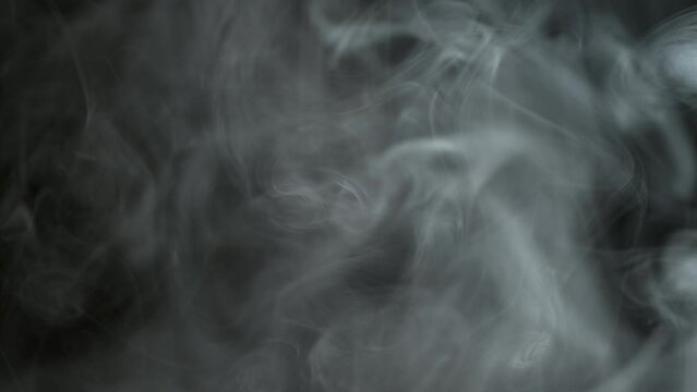 Smoke and steam moving on black background