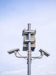 Street surveillance camera on a pole. Transformer panel. Against crime. Recording on a stationary camera. Fighting crime. Concept of issuing a fine. Traffic monitoring.
