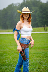 A Lovely Red Headed Country Wetern Model Poses Outdoors In A Country Setting