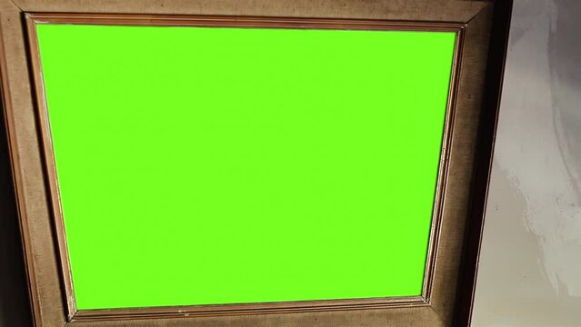 Wood Frame Mirror Green Screen. Close Up. You can replace green screen with the footage or picture you want. You can do it with “Keying” effect in After Effects. 4K.