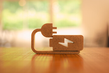 Battery charge indicator wood model, Technology battery high power electric energy with a connected charging cable. Battery to electric cars and mobile devices with clean electric.