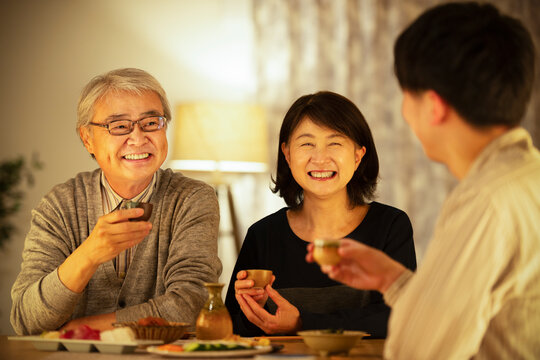 日本酒で晩酌をする親子