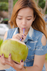 Fototapeta premium girl eating coconut.