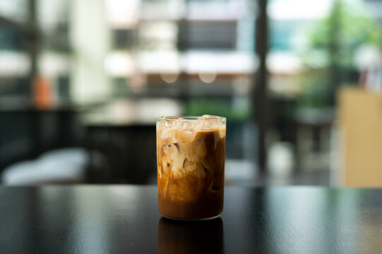 Iced coffee in a coffee shop blur background with bokeh image