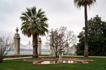 Marble fountain on the territory of the Dolmabahce Palace on the shore of the Bosphorus Strait in the European part of Istanbul in the Besiktas district on a cloudy day, Istanbul, Turkey