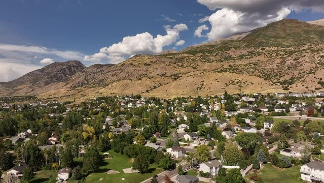Aerial Lindon Utah construction neighborhood to temple . Lindon in Utah County, Utah. Part of the Provo Orem, Utah Metropolitan Area. Summer season in Wasatch Mountain range valley. Residential homes.