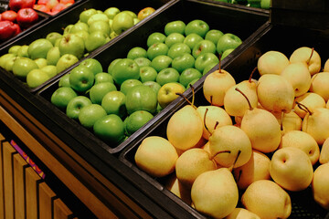 Nicely arranged a freshness fruits display for sell in the supermarket. Chinese pear, green apples