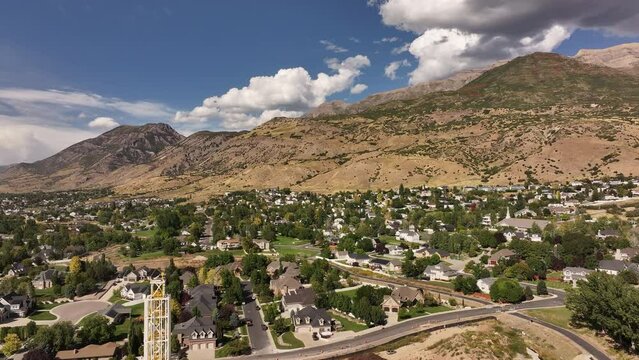 Aerial Lindon Utah construction neighborhood to temple . Lindon in Utah County, Utah. Part of the Provo Orem, Utah Metropolitan Area. Summer season in Wasatch Mountain range valley. Residential homes.