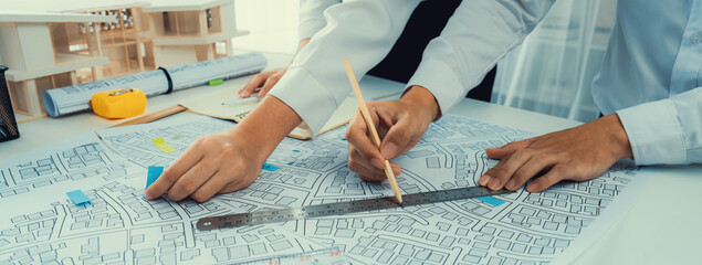 Worker, architect and engineer work on real estate construction project oratory planning with...