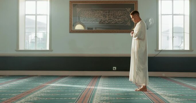 Praying, islamic and man with faith in a mosque for praying, peace and spiritual care in holy religion for Allah. Respect, Ramadan and Muslim person on floor mat, hope and humble after worship
