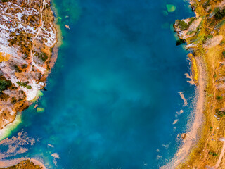 Autumn colors on Lake Federa. Dolomites from above