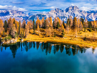 Autumn colors on Lake Federa. Dolomites from above