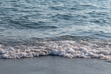 Beautiful soft sea wave on a sandy beach. Close, no people. Sea waves, textures, background