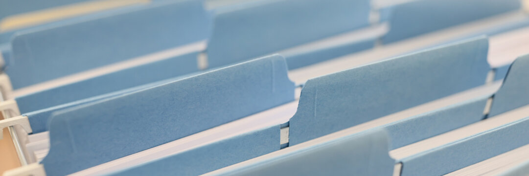 Many file folders in a row as background.