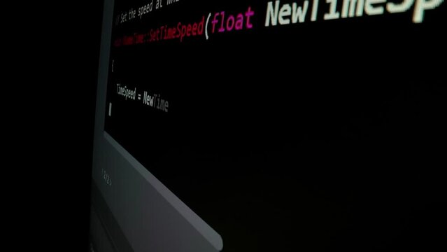 Closeup macro shot movement of coding script moving across LED screen with real-time AI-generated typing, showcasing advanced AI learning in optimization, debug and coding for software development.
