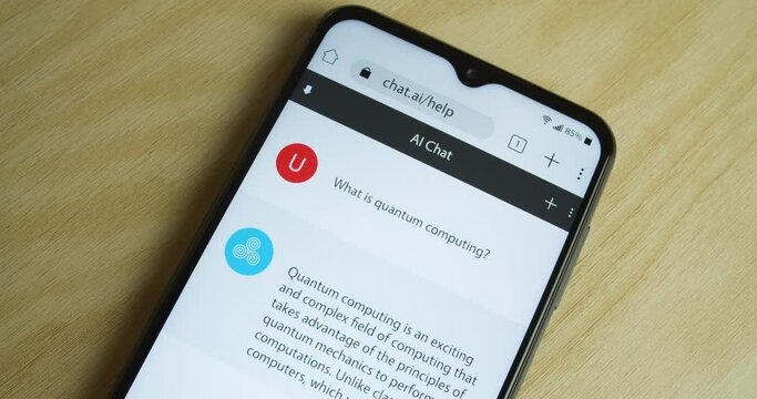 Artificial Intelligence - AI chat bot app on smartphone - Royalty free phone and app interface - Close shot, only phone - "What is quantum computing?"