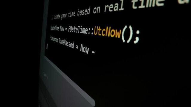 Closeup macro shot movement of coding script moving across LED screen with real-time AI-generated typing, showcasing advanced AI learning in optimization, debug and coding for software development.