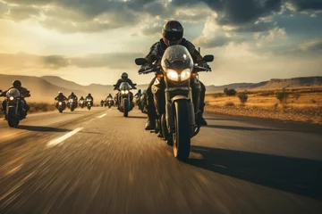 Fotobehang A gathering of motorcyclists riding together. A group of bikers ride fast motorcycles on an empty road against a beautiful cloudy sky. Sport bikes are fast, and fun to ride. © sirisakboakaew