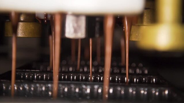 Cake moulds being filled at a cake production factory, Slow motion closeup shot