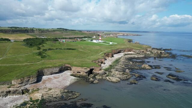 Aerial drone shot of Souter Lighthouse and sea coastline Sunderland North East England. South Sheilds, Marsden and Whitburn. Drone moves left to right. 4K