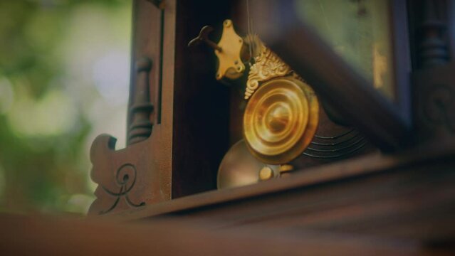 antique pendulum clock in a forest door open low angle close up pendulum shot slow motion