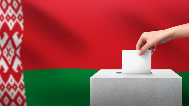 Woman puts ballot paper in voting box on BELARUS flag background. Election concept.
