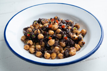 Stewed chickpeas with black pudding and red pepper. Traditional tapas from Barcelona.